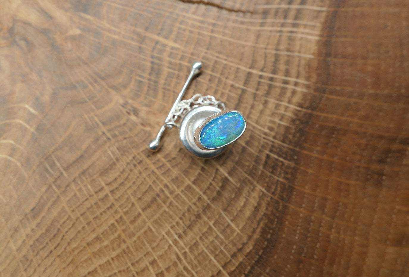 Silver tie tack with a Coober Pedy opal