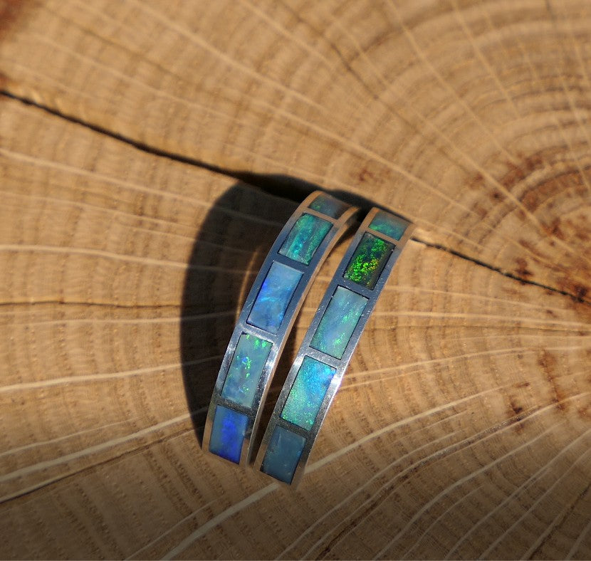 Silver hoop earrings with bright opal inlay
