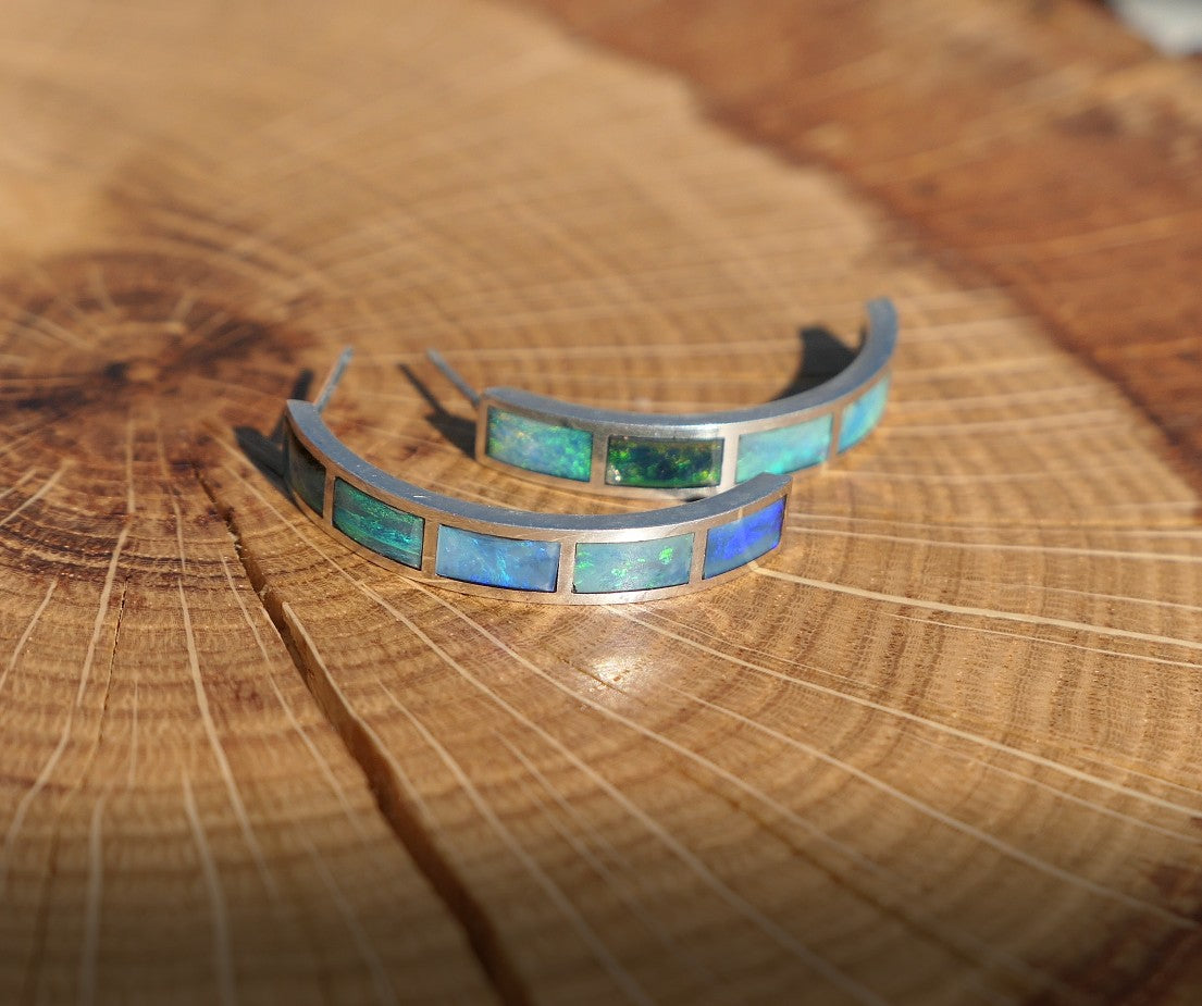Silver hoop earrings with bright opal inlay