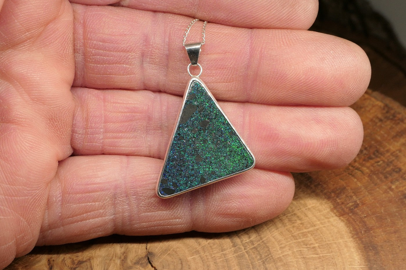 Silver opal pendant with an Andamooka matrix opal