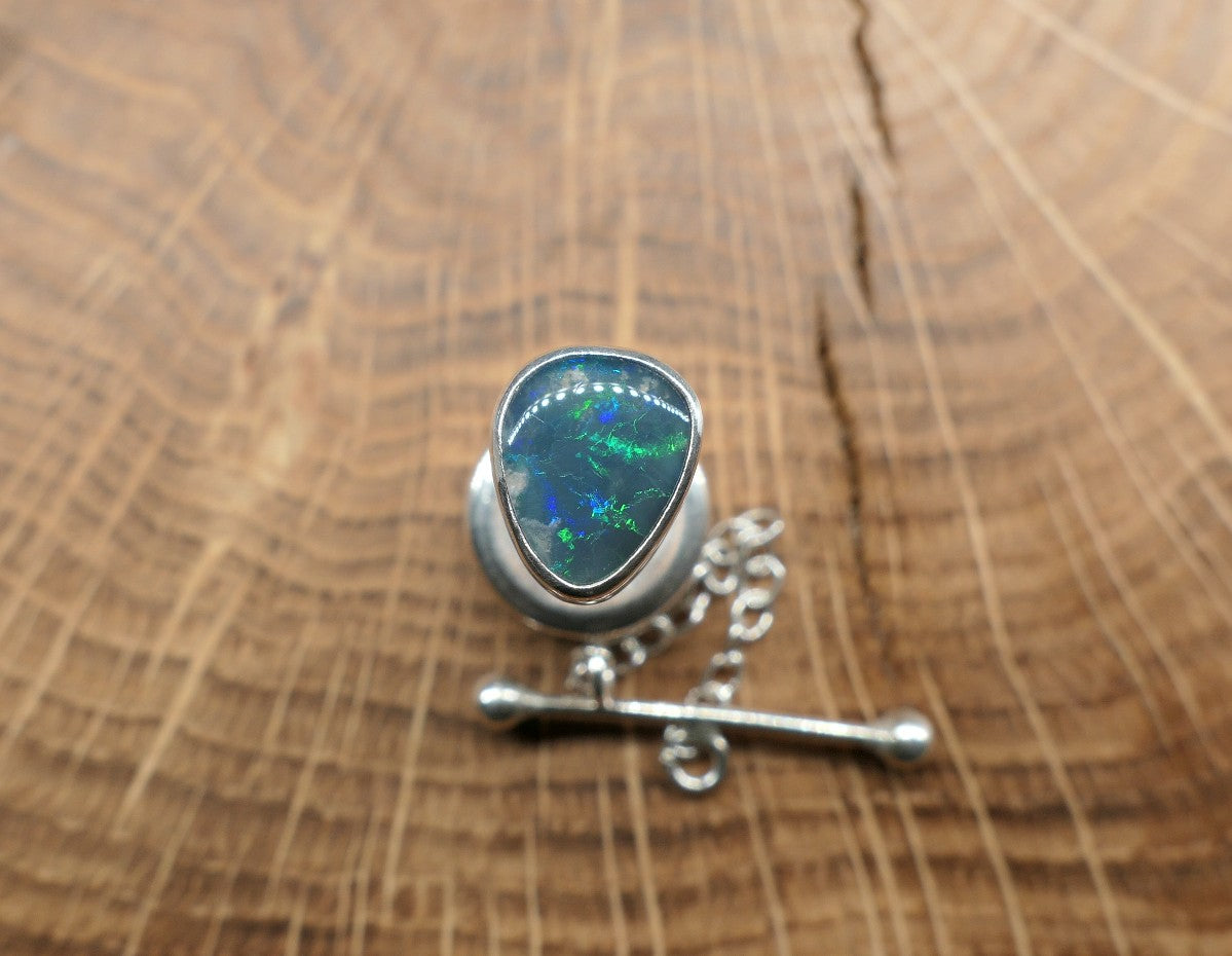 Silver tie tack with a Lightning Ridge doublet.