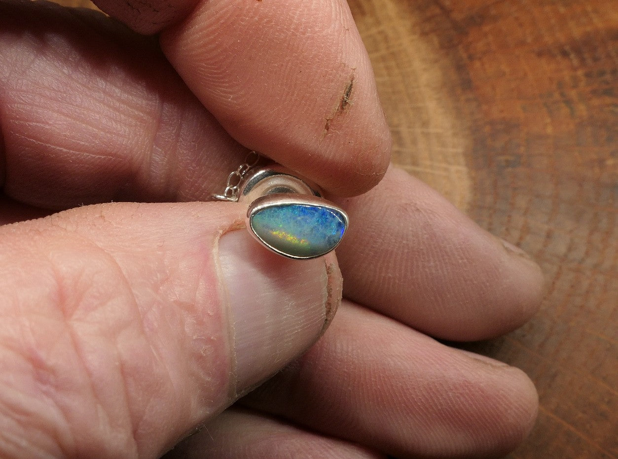 Silver tie tack with an opalised shell doublet