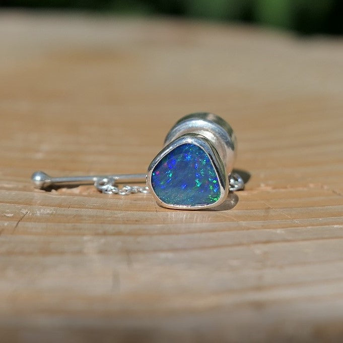 Silver tie tack with a bright Andamooka doublet opal.