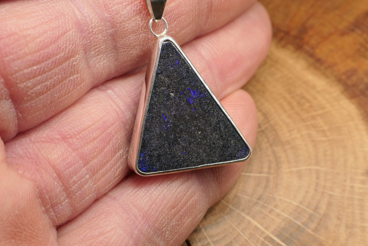 Silver opal pendant with an Andamooka matrix opal