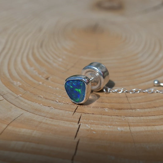 Silver tie tack with a bright Andamooka doublet opal.