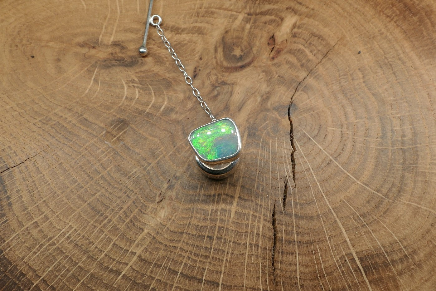 Silver tie tack with a Coober Pedy opal