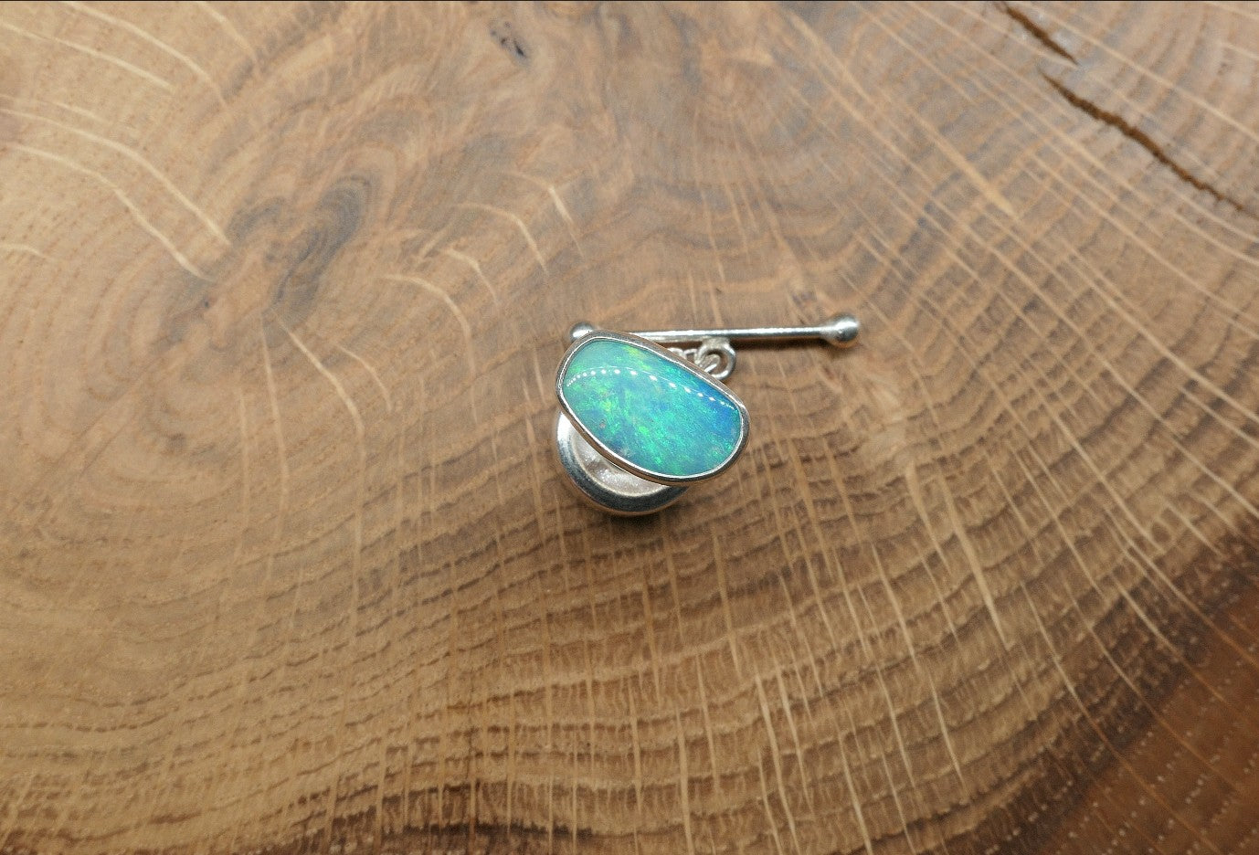 Silver tie tack with a Coober Pedy opal
