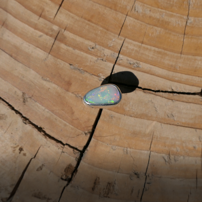 Silver tie tack with Coober Pedy solid opal.