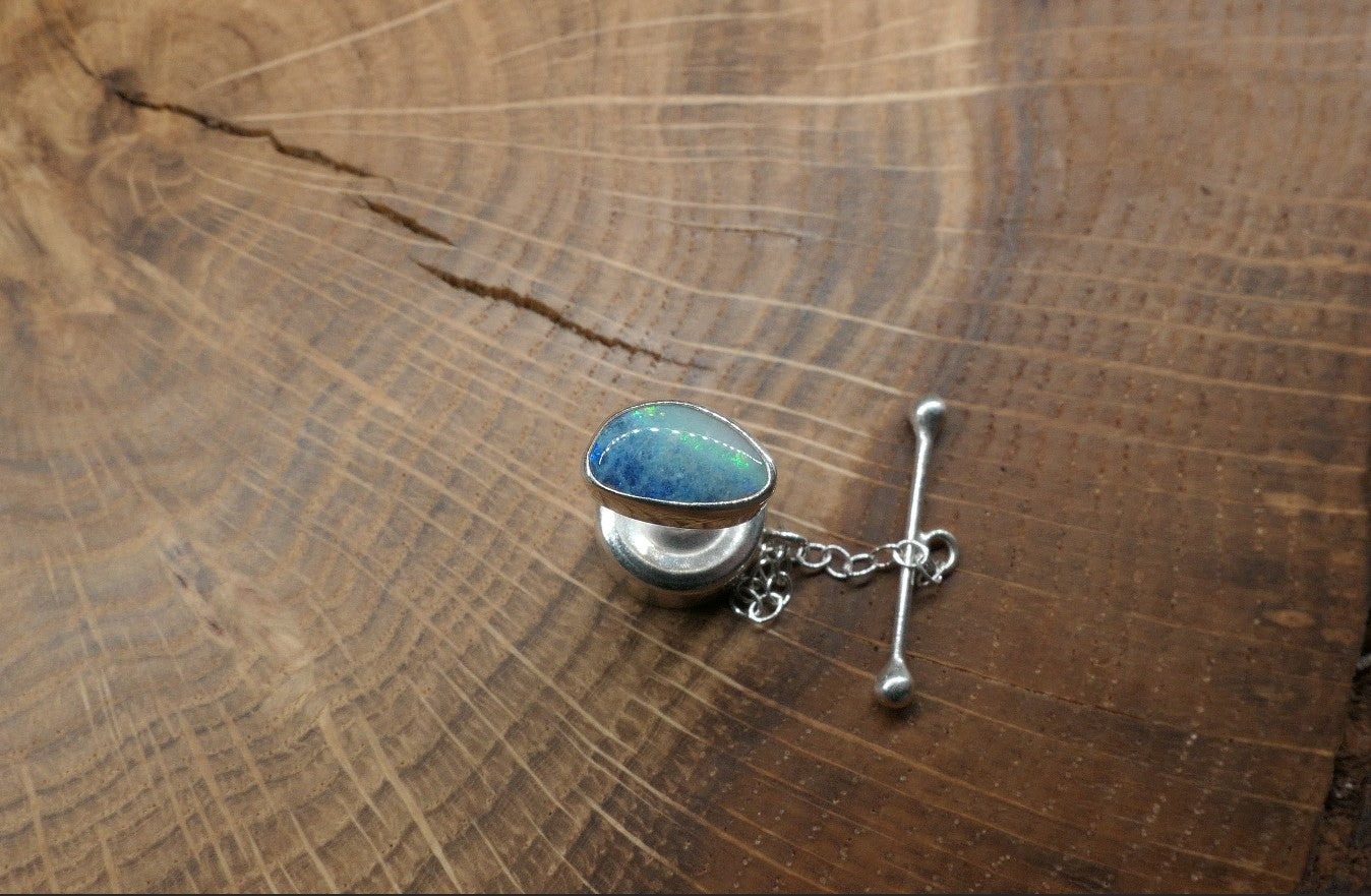 Silver tie tack with an opalised shell doublet