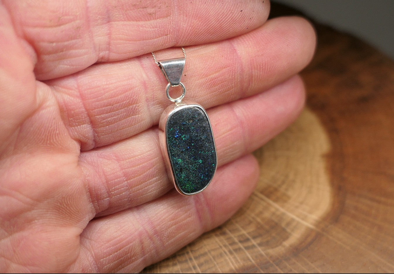 Silver opal pendant with an Andamooka marix opal