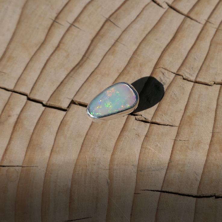 Silver tie tack with Coober Pedy solid opal.