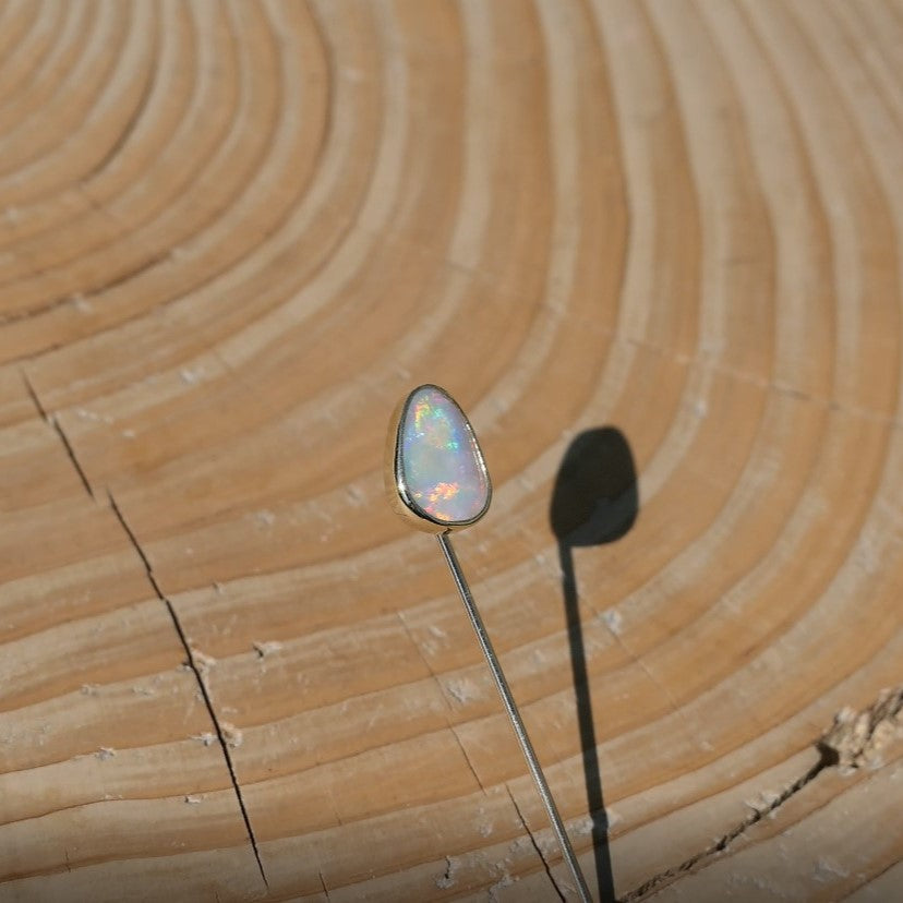 18k gold tie/lapel pin with a brilliant Lightning Ridge crystal opal.