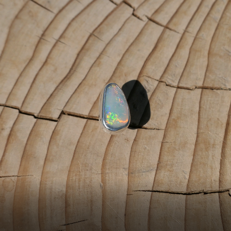 Silver tie tack with Coober Pedy solid opal.