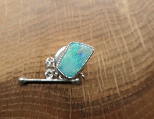 Silver tie tack with a Coober Pedy opal