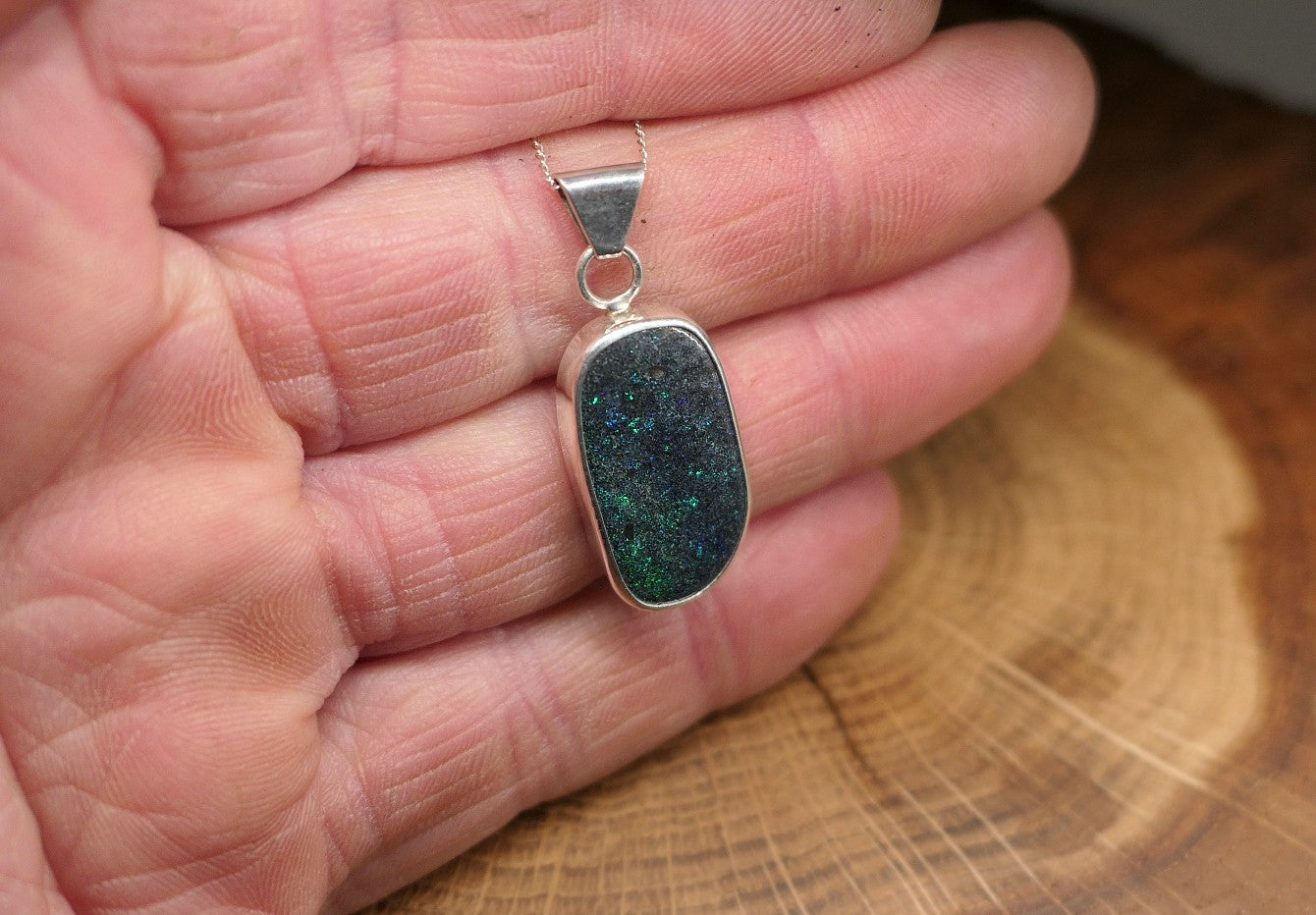 Silver opal pendant with an Andamooka marix opal