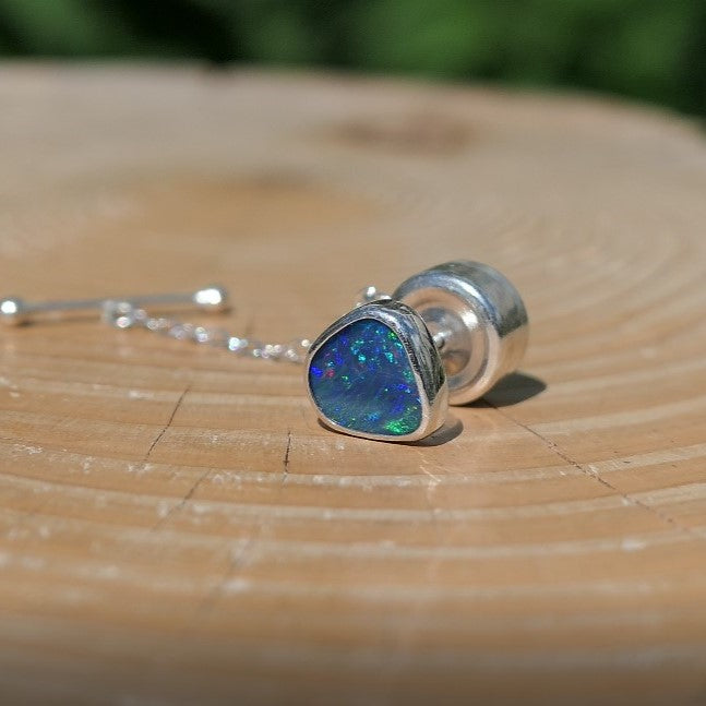 Silver tie tack with a bright Andamooka doublet opal.