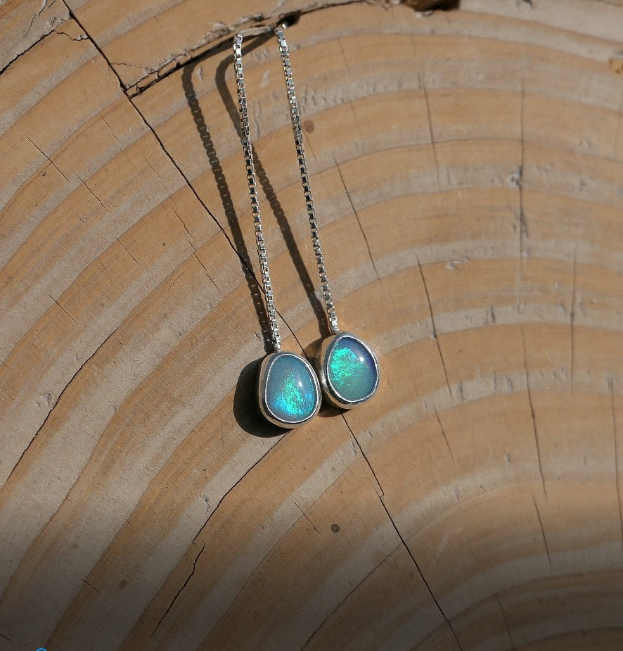 Silver dangle and drop earrings, with a pair of Andamooka opals with bright green and blue rolling flash.  Earrings are 55mm long, opals are 8x4mm approximately.