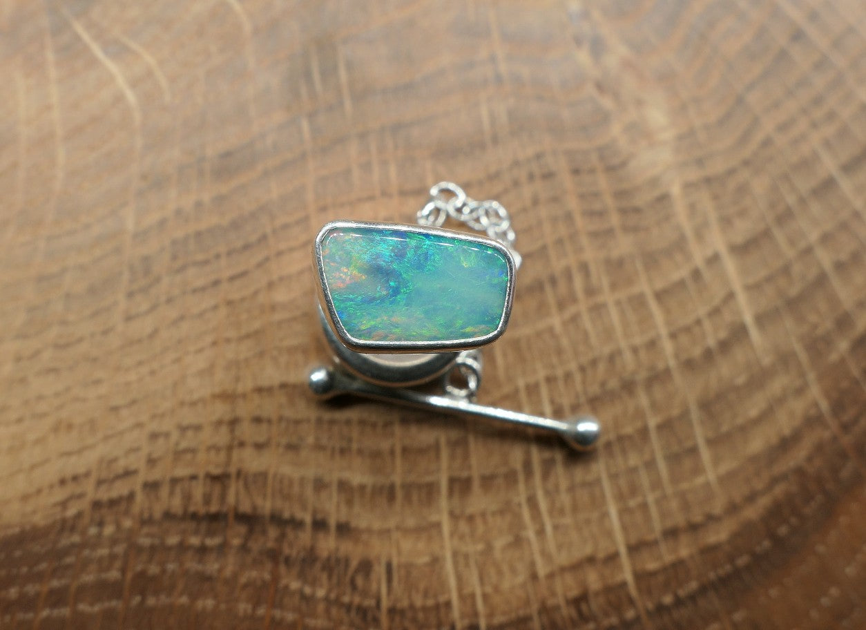 Silver tie tack with a Coober Pedy opal