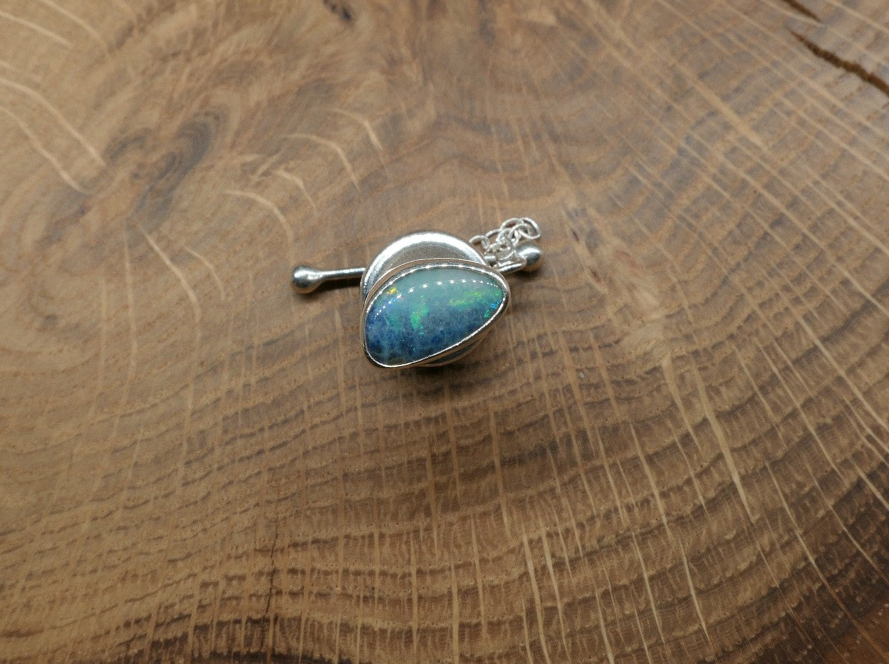 Silver tie tack with an opalised shell doublet