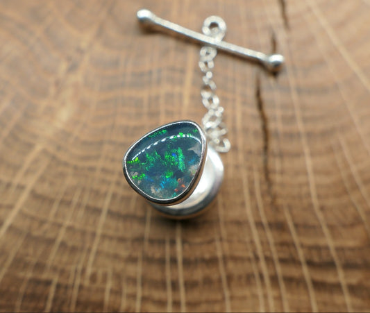 Silver tie tack with a Lightning Ridge doublet.