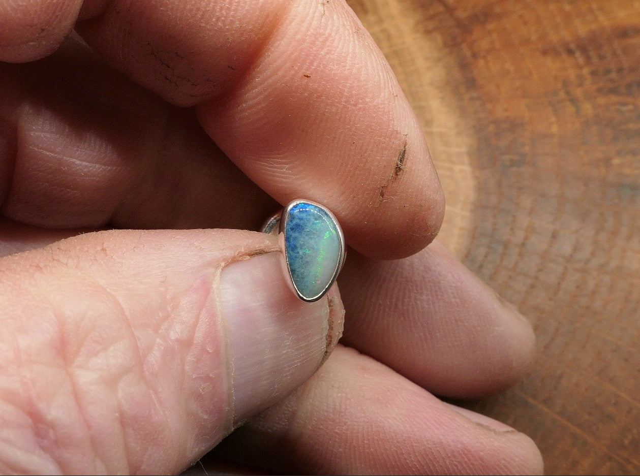 Silver tie tack with an opalised shell doublet