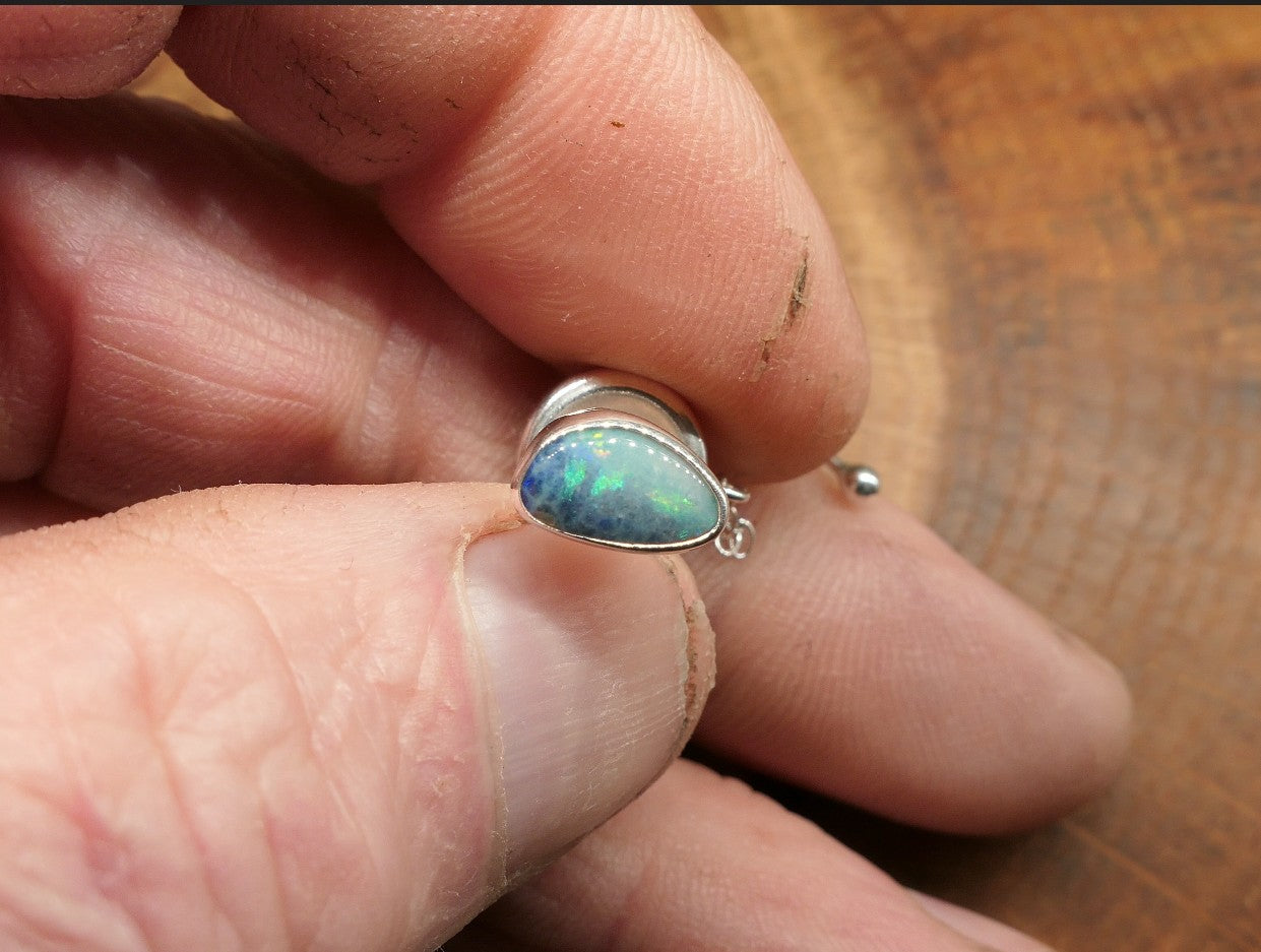 Silver tie tack with an opalised shell doublet