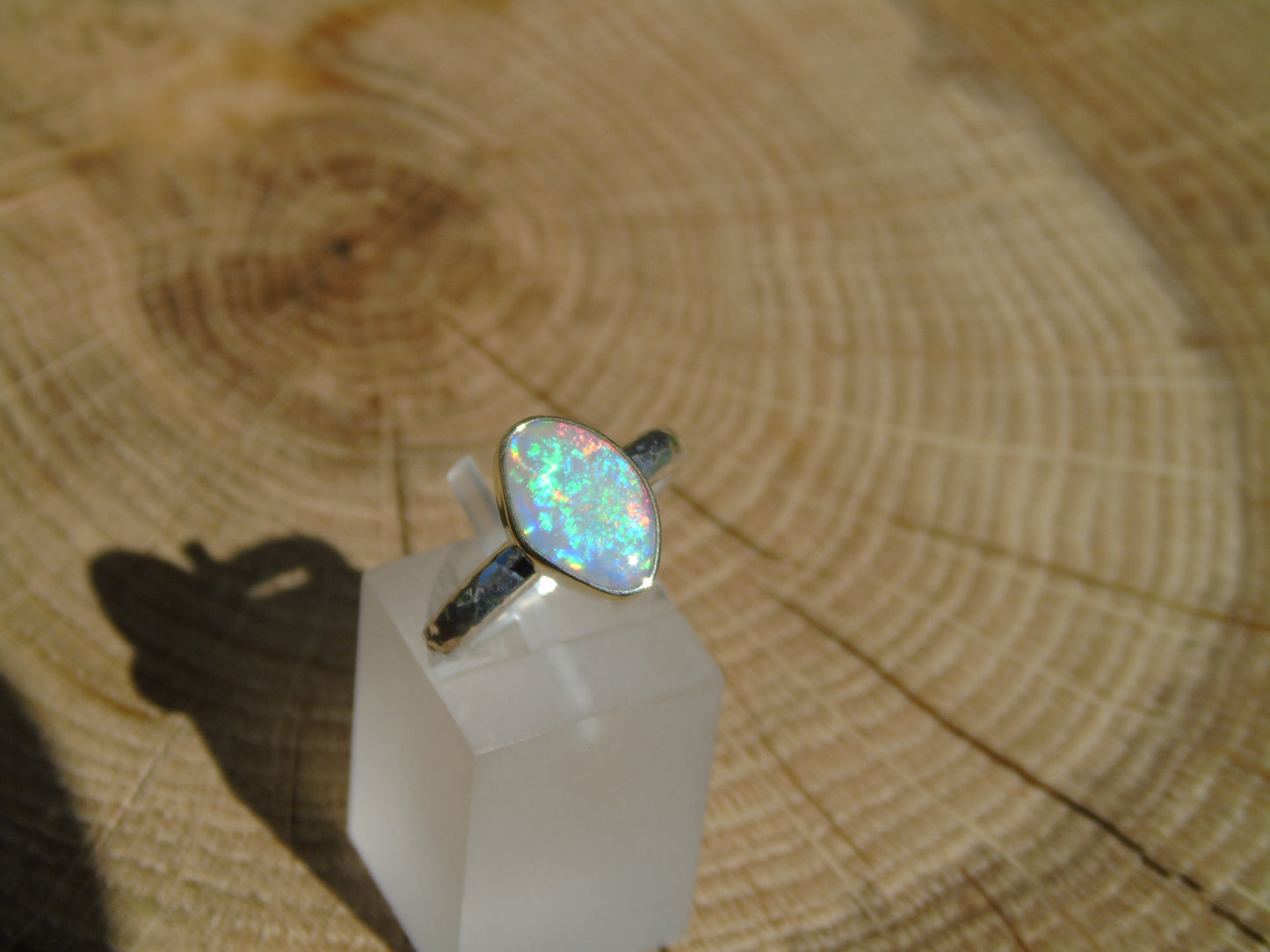 Lightning Ridge opal ring with 18k gold bezel