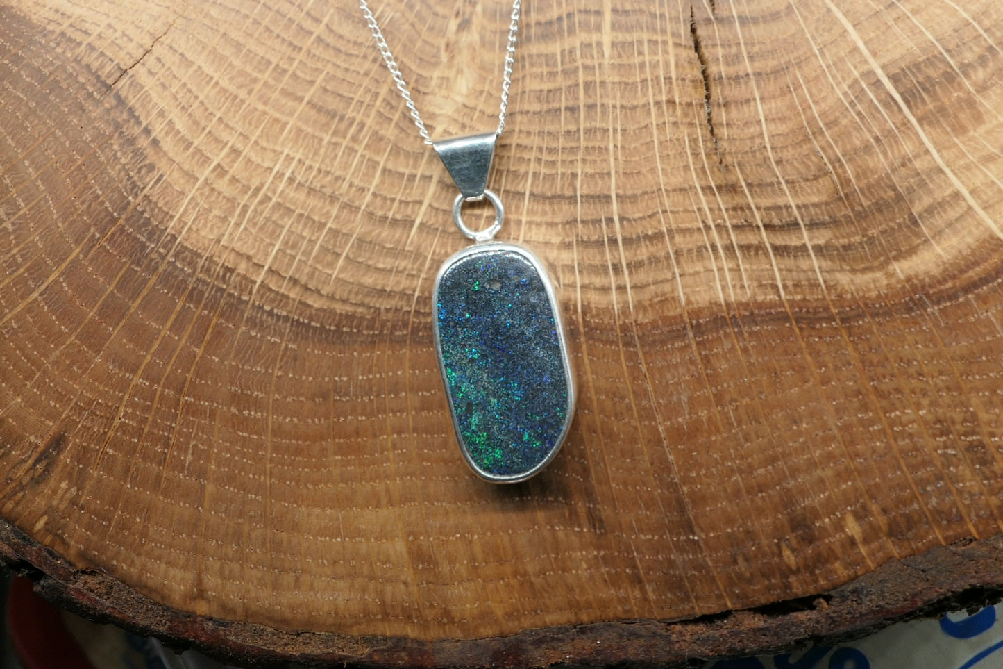 Silver opal pendant with an Andamooka marix opal
