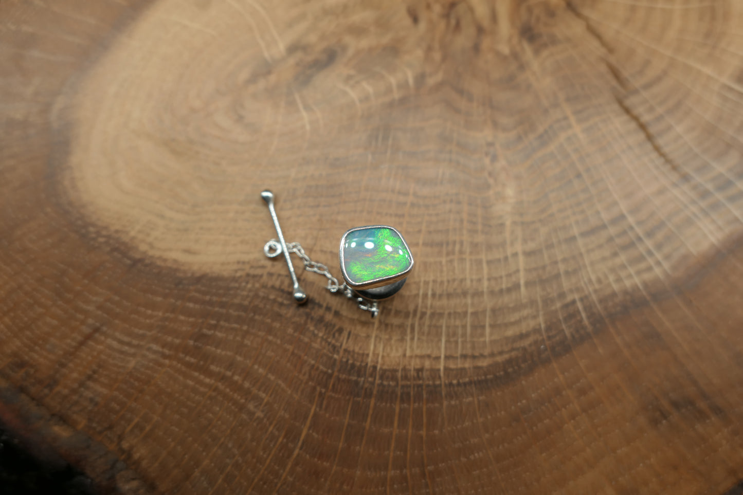 Silver tie tack with a Coober Pedy opal