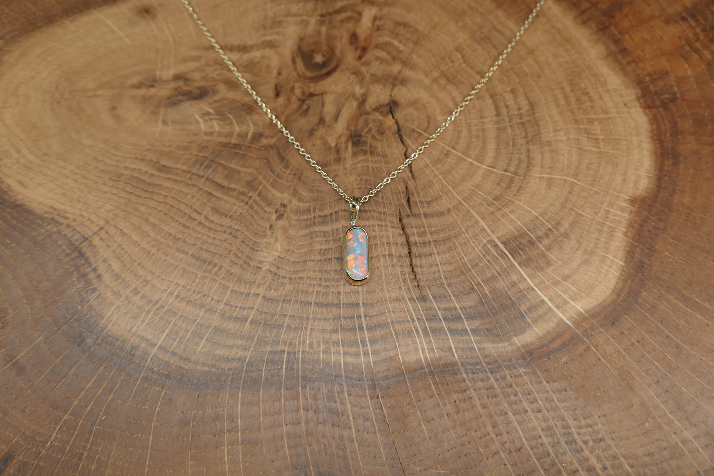 18k gold opal pendant with a Lightning Ridge black opal