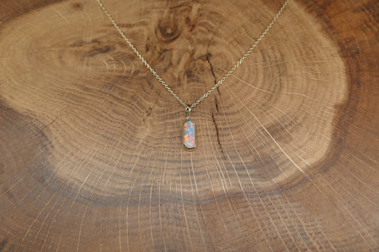 18k gold opal pendant with a Lightning Ridge black opal