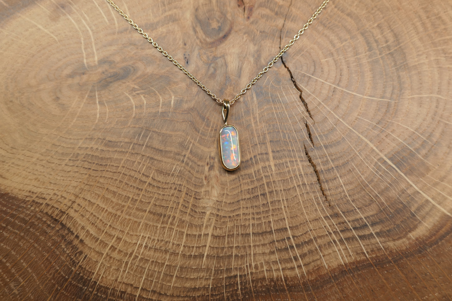 18k gold opal pendant with a Lightning Ridge black opal