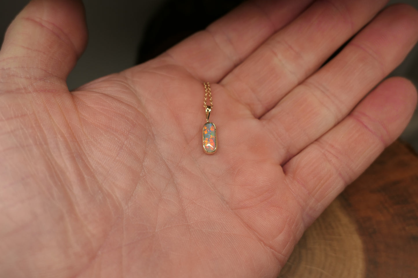 18k gold opal pendant with a Lightning Ridge black opal