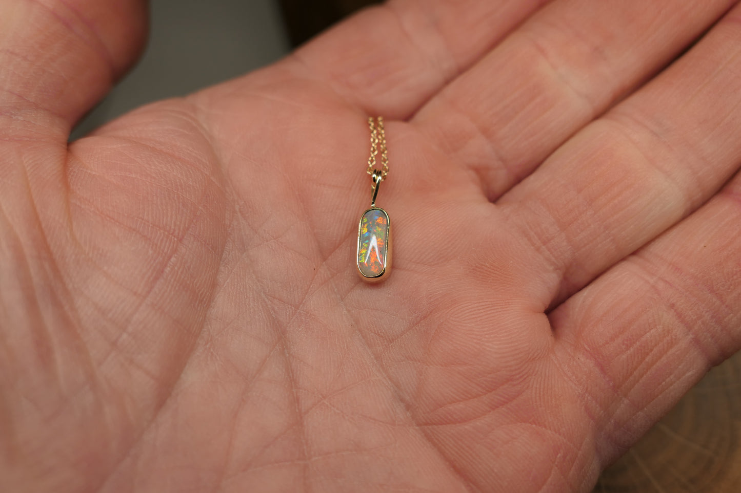 18k gold opal pendant with a Lightning Ridge black opal