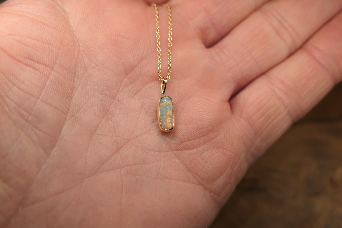 18k gold opal pendant with a Lightning Ridge black opal