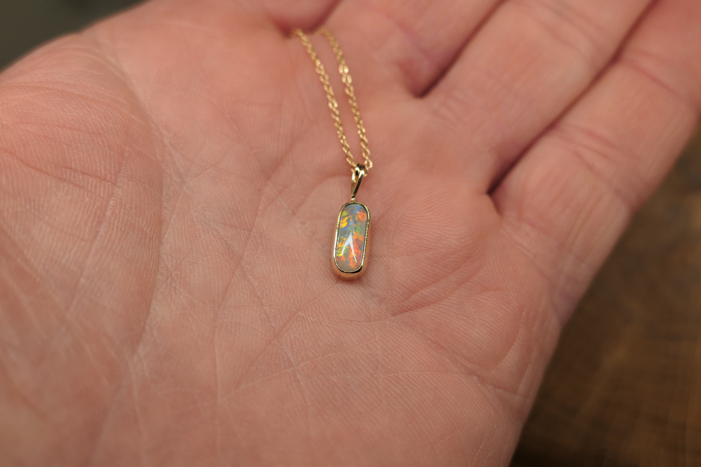 18k gold opal pendant with a Lightning Ridge black opal