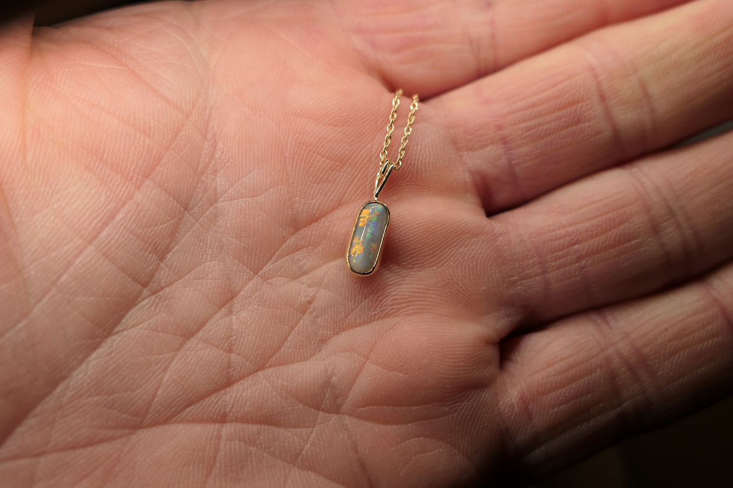 18k gold opal pendant with a Lightning Ridge black opal