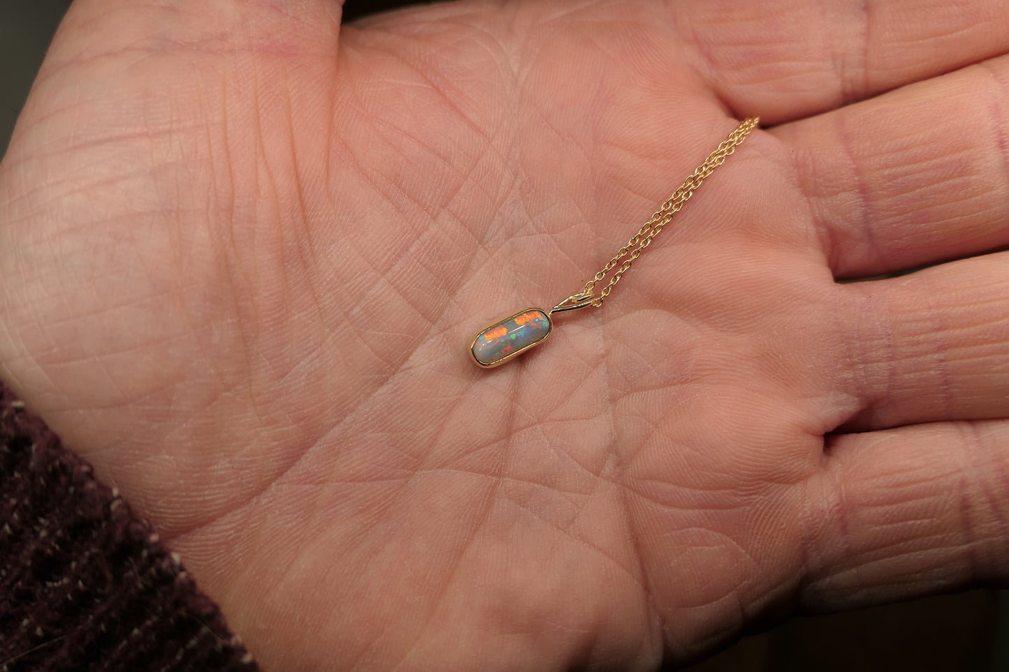 18k gold opal pendant with a Lightning Ridge black opal