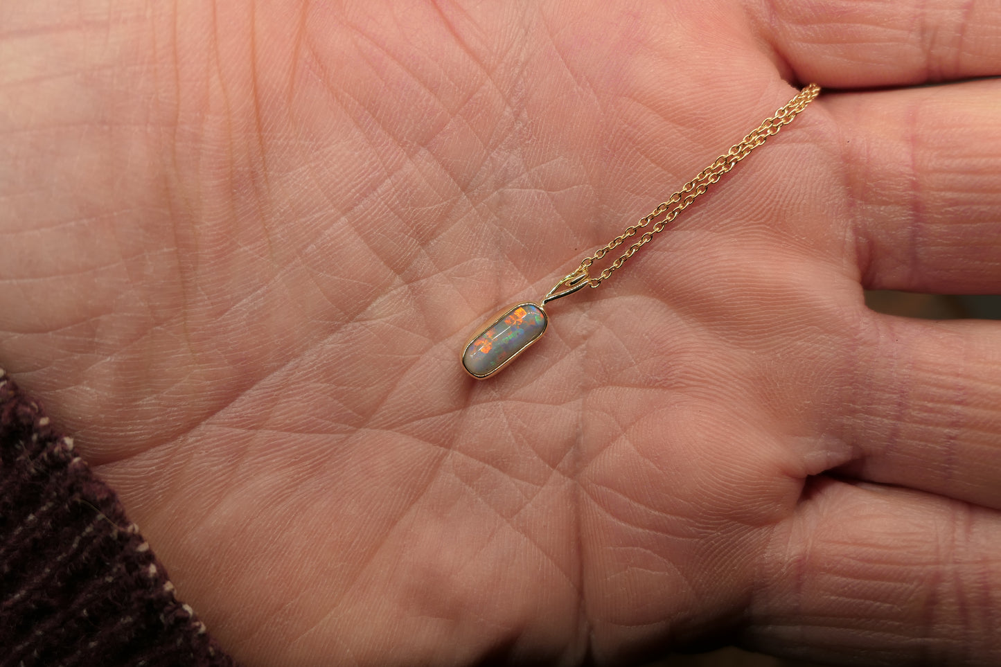 18k gold opal pendant with a Lightning Ridge black opal