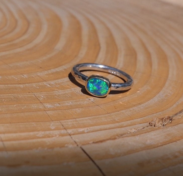 Lightning Ridge opal ring with 18k gold bezel