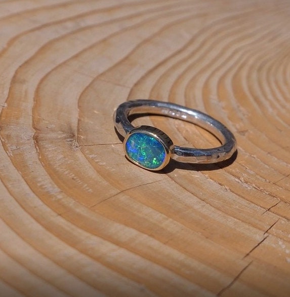 Lightning Ridge opal ring with 18k gold bezel